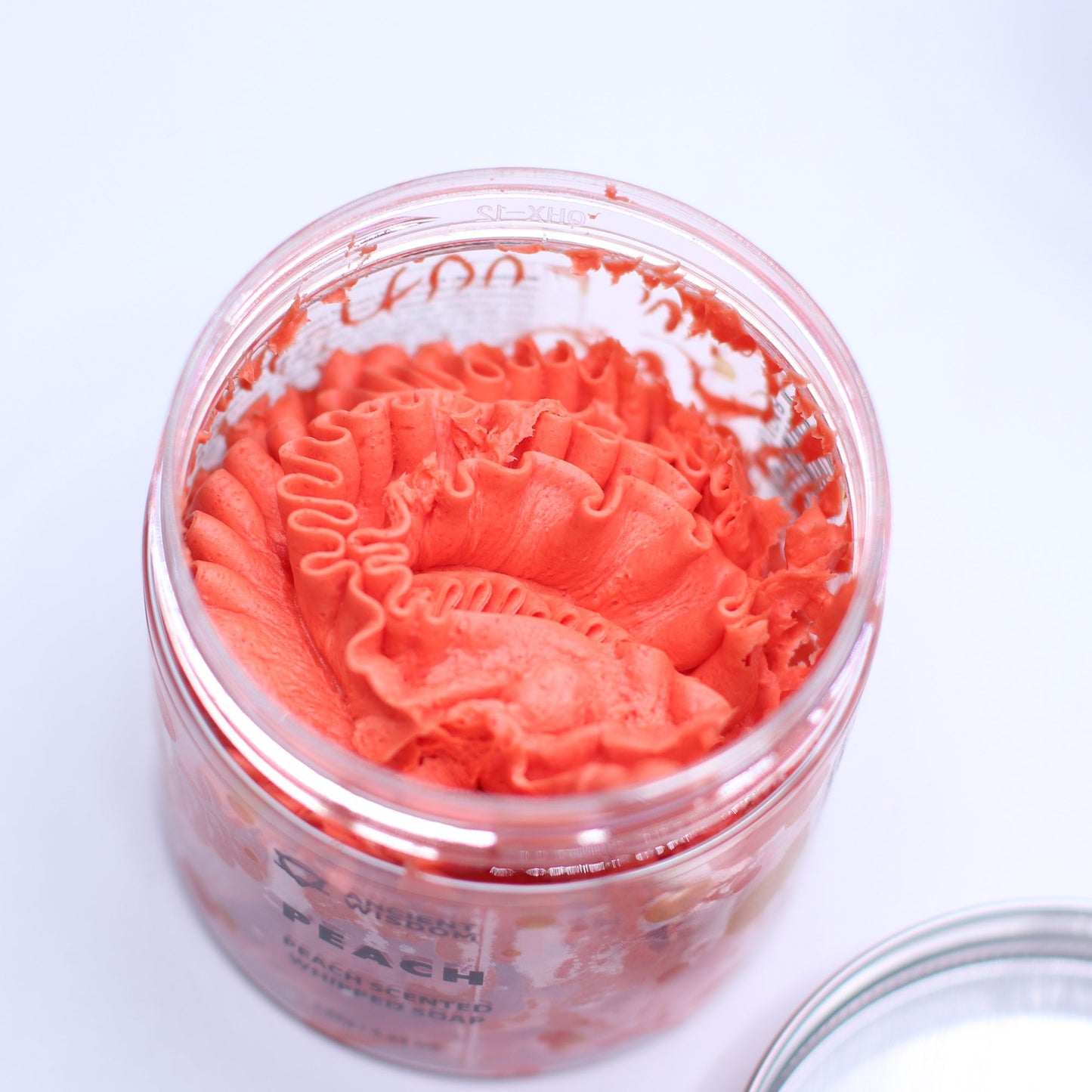 Peach whipped soap with sweet juicy peach fragrance and soft whipped texture in a clear jar