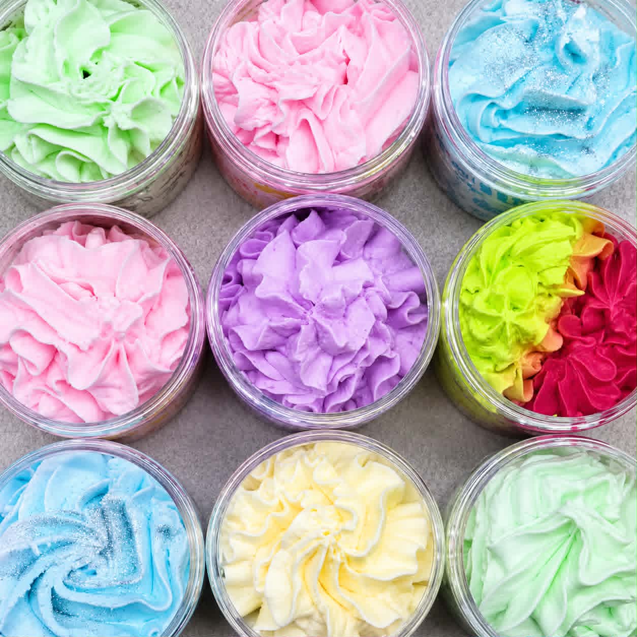 Open whipped soap jars displaying creamy textures and vibrant fragrances