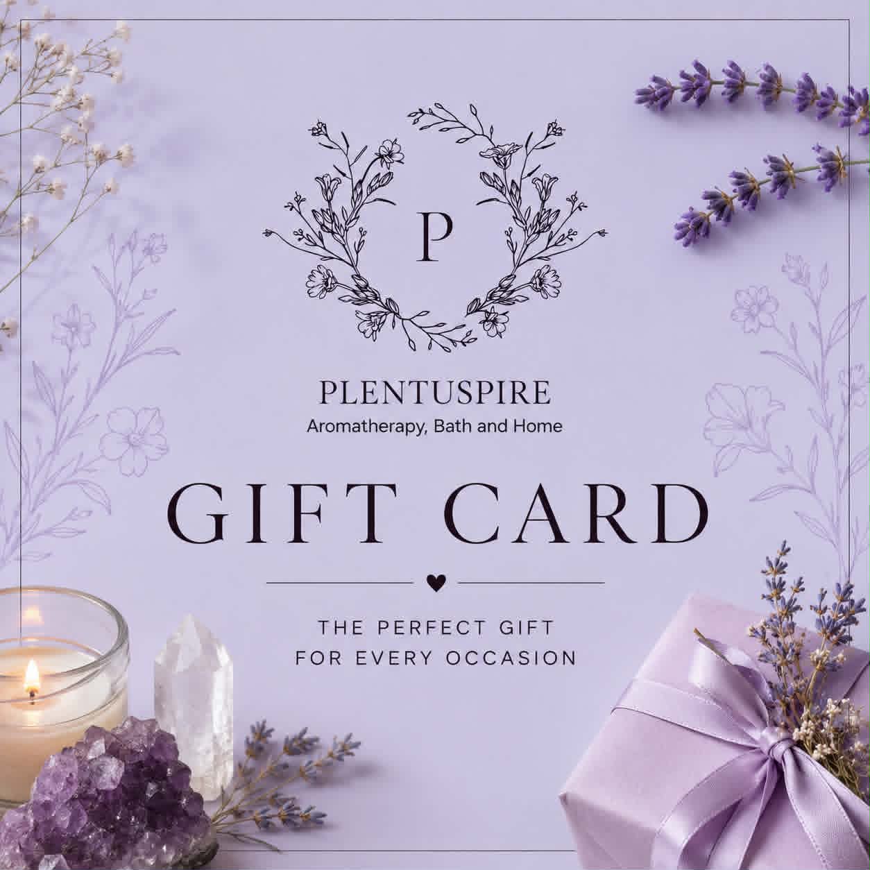 A lavender gift card with elegant black typography reading 'PLENTUSPIRE Aromatherapy, Bath and Home GIFT CARD THE PERFECT GIFT FOR EVERY OCCASION,' surrounded by spa-themed props including a lit candle, purple crystals, dried lavender sprigs, and a lavender gift box.