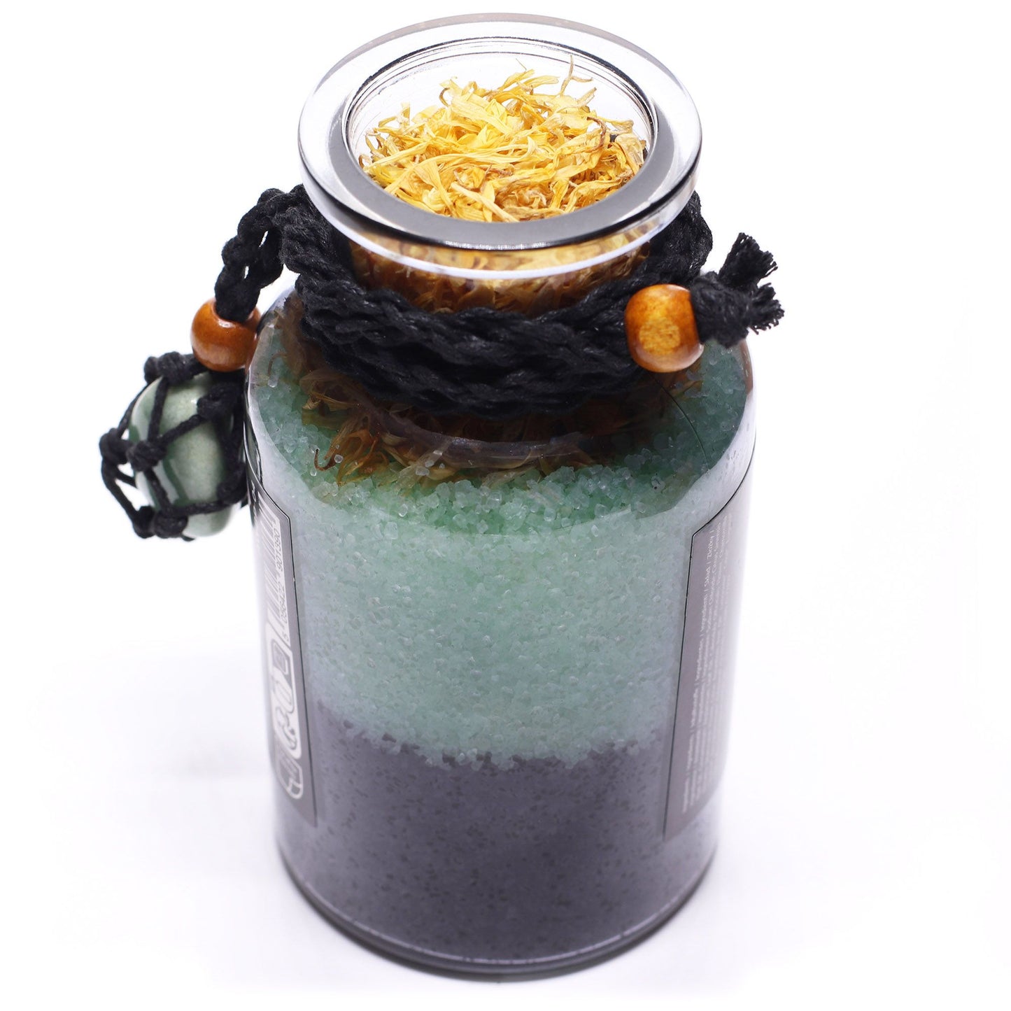 Glass bottle with cork lid off filled with Himalayan bath salts, marigold and chamomile botanicals with Orange and Cinnamon essential oils and a green Aventurine crystal amulet from aove