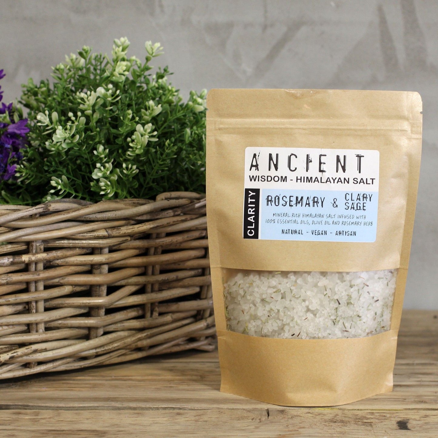 Resealable paper bag of Himalayan bath salts infused with Rosemary and Clary Sage essential oils, Olive Oil and dried Rosemary botanicals