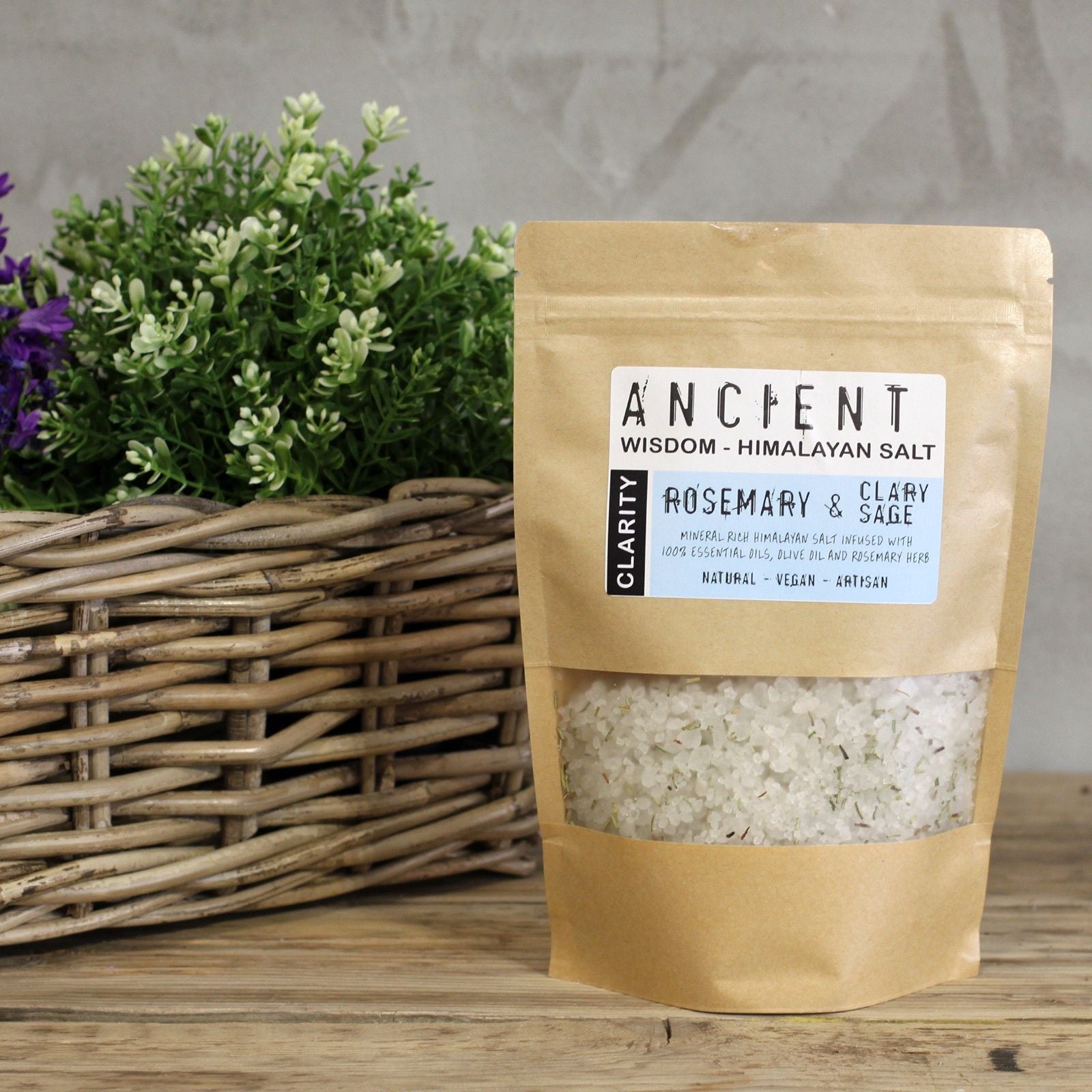 Resealable paper bag of Himalayan bath salts infused with Rosemary and Clary Sage essential oils, Olive Oil and dried Rosemary botanicals