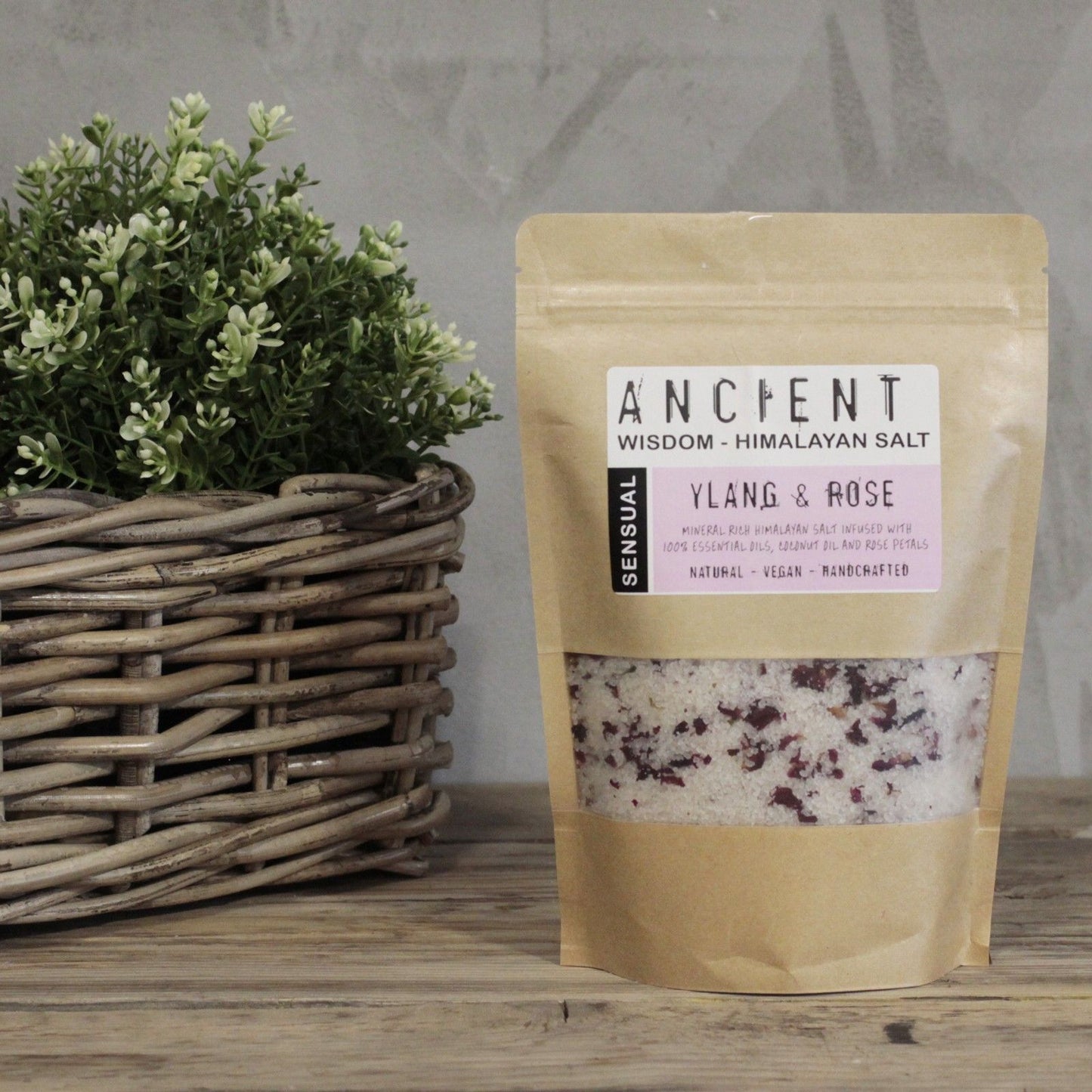 Resealable paper bag of Himalayan bath salts infused with Ylang Ylang essential oil, Coconut Oil and dried Rose petals