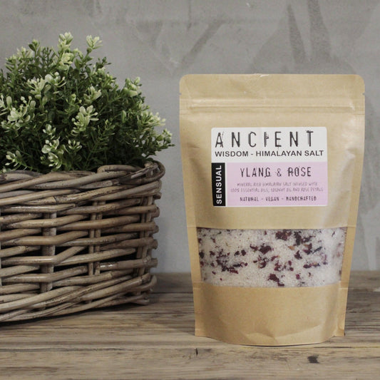 Resealable paper bag of Himalayan bath salts infused with Ylang Ylang essential oil, Coconut Oil and dried Rose petals