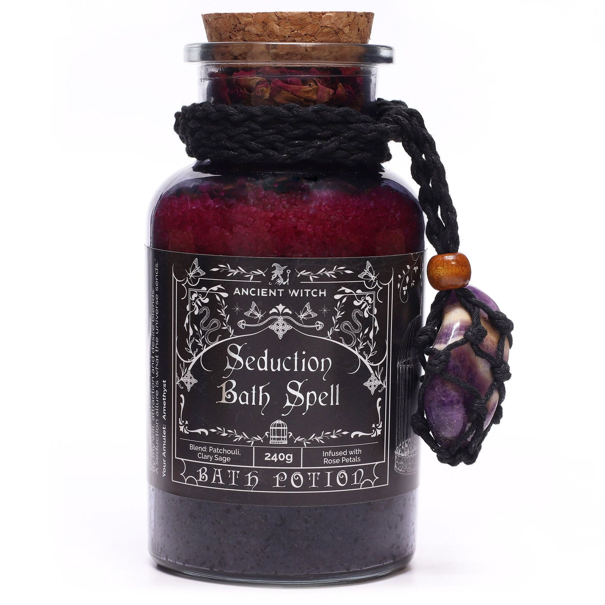 Glass bottle with cork lid filled with Himalayan bath salts, rose petals and essential oils with an Amethyst crystal amulet