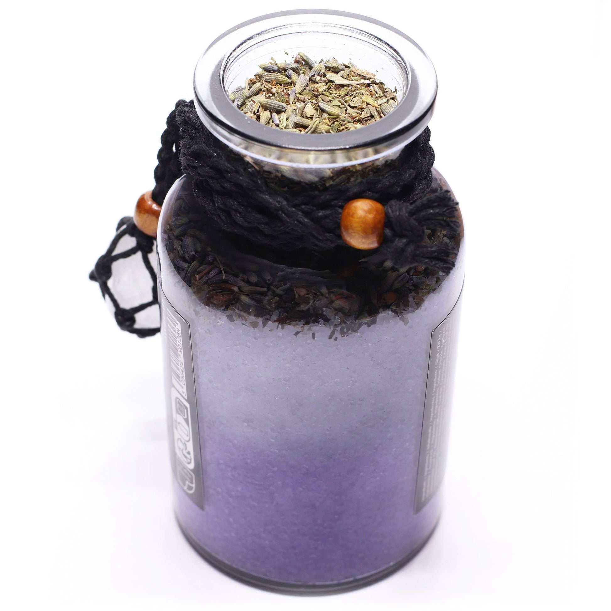 Glass bottle with cork lid off filled with Himalayan bath salts, lavender and botanicals infused with Cypress, Rosemary and Lemongrass essential oils with a Clear Quartz crystal amulet from above